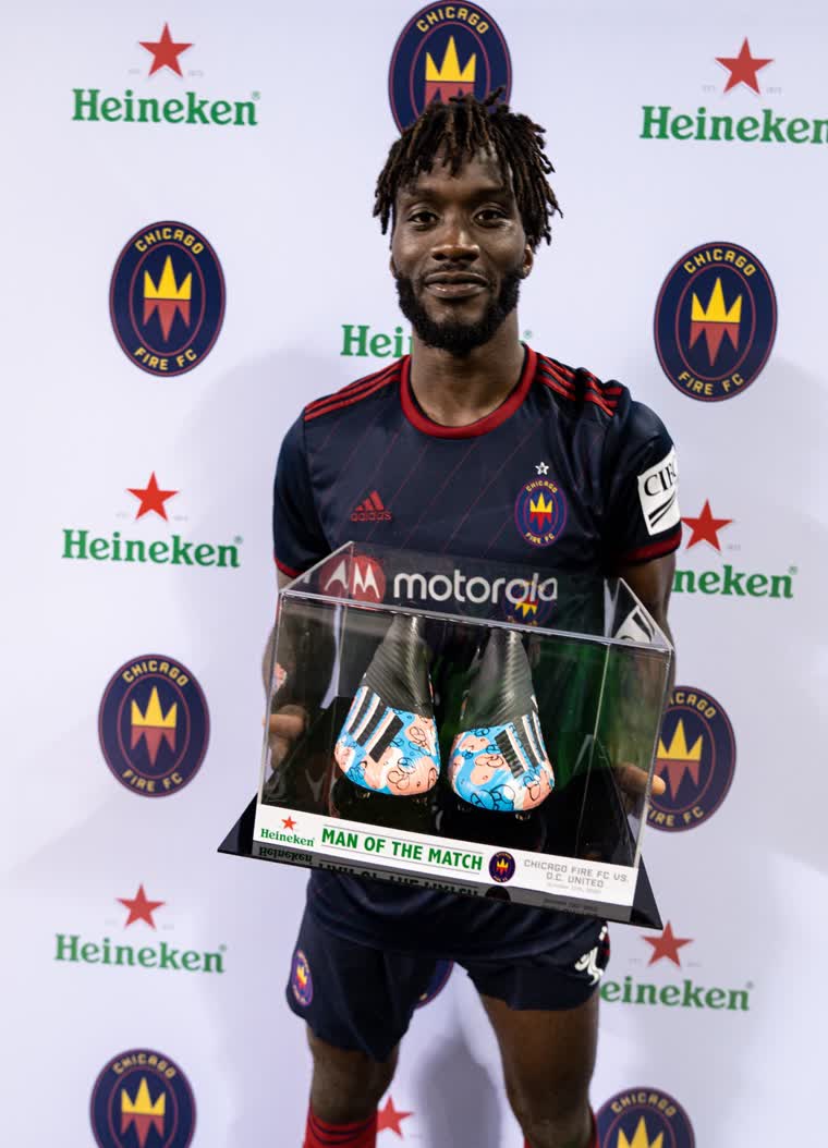 CJ Sapong holding his Man of the Match award.